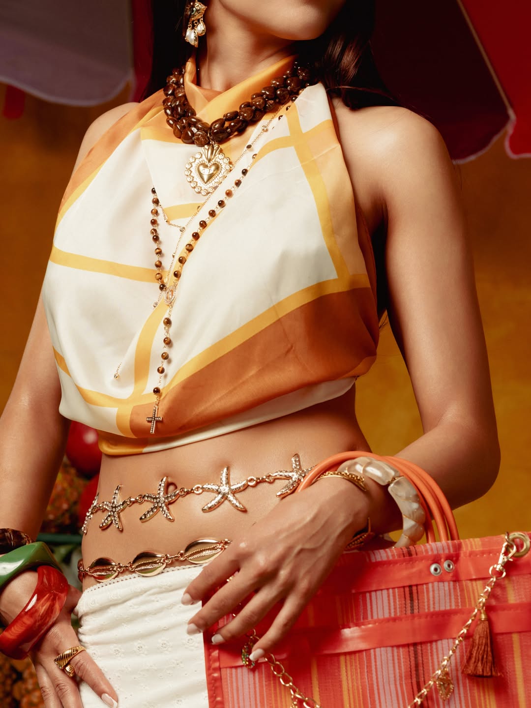 Detail of the Mi Pecado scarf top and layered gold jewelry